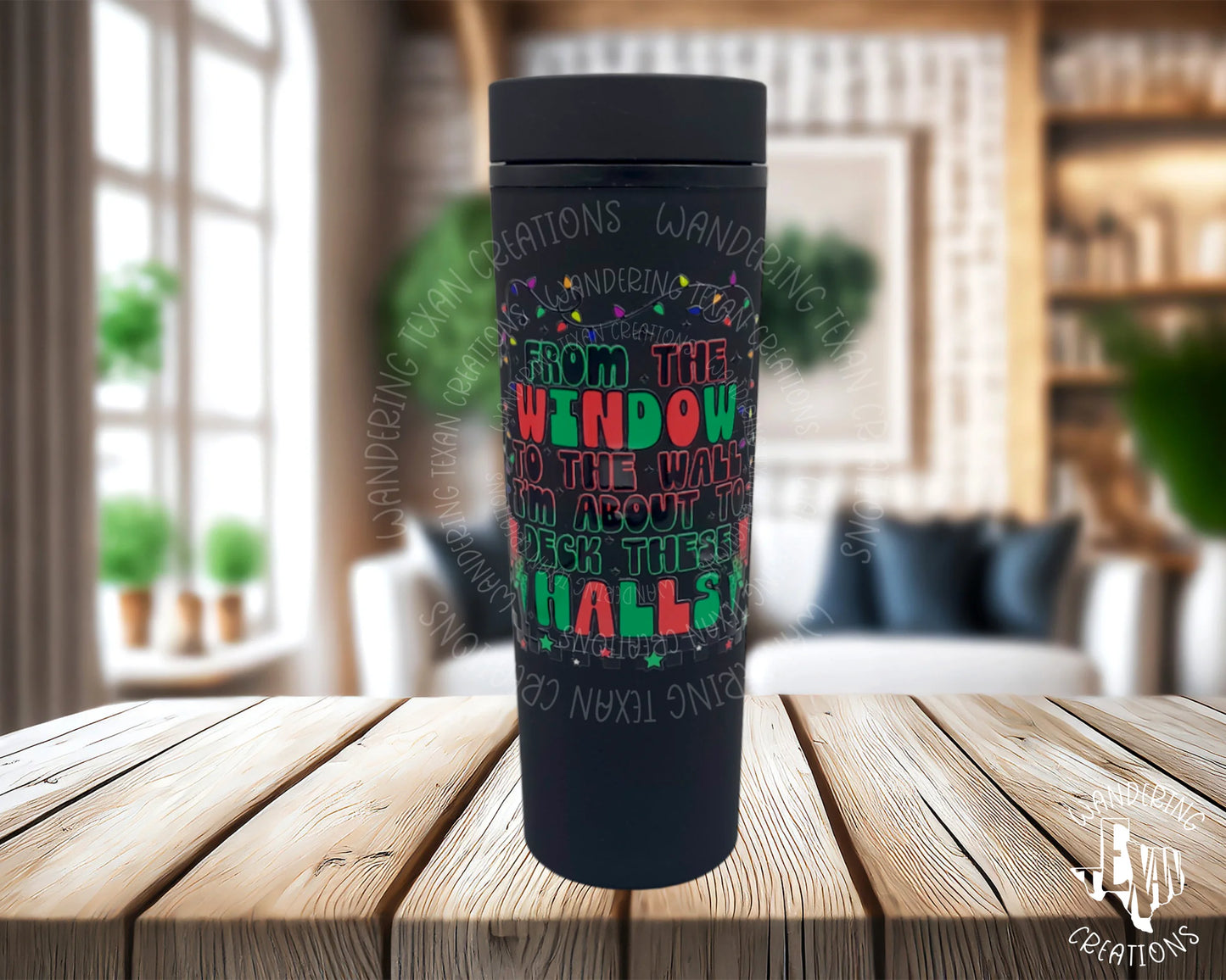 With a festive UV DTF decal featuring the iconic phrase "from the window to the wall, I'm about to deck these halls" and entwined Christmas lights, this tumbler is sure to bring a playful and quirky touch to your celebrations. 