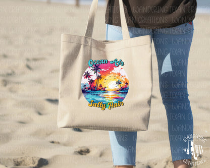 This tote bag features a vibrant sublimation design of a neon beach and ocean scene, complete with the playful phrase "Ocean Air, Salty Hair".