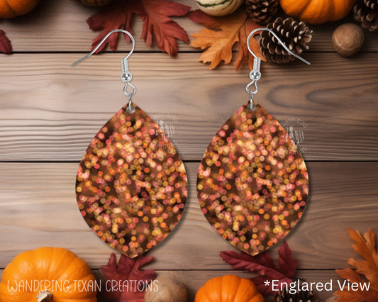 These leaf-shaped earrings feature a unique sublimated design of bokeh lights in the vibrant color of pumpkin spice.