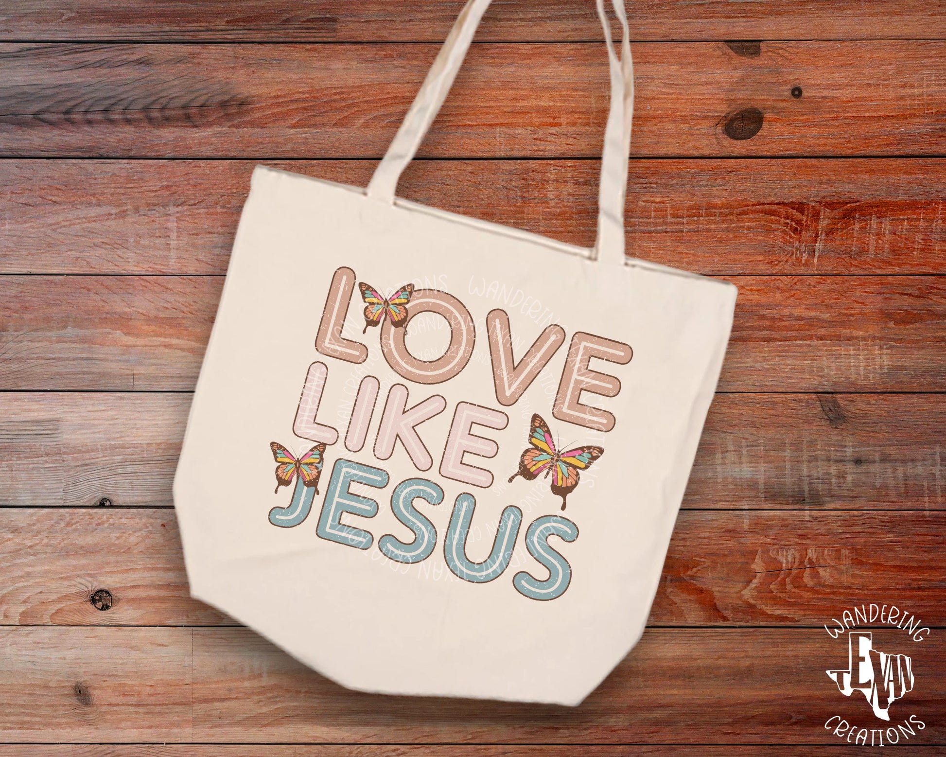 Crafted with the phrase "Love like Jesus" and butterflies in a stylish sublimation design, it's perfect for carrying your essentials in attractive, uplifting style.