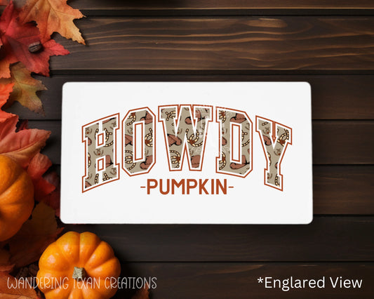 This rectangle-shaped magnet features a sublimated design of the punny phrase "Howdy Pumpkin," with the word "howdy" playfully filled with western items.