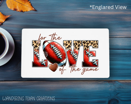 The rectangle magnet features a fun and playful design with the phrase "For the love of the game" creatively incorporating footballs and leopard print.