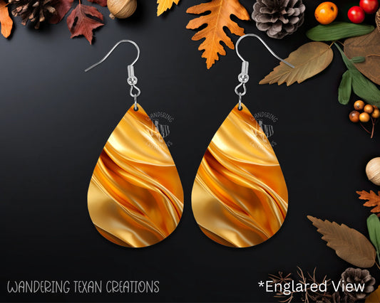 Get ready to shine like the harvest sun with our unique teardrop-shaped earrings! The sublimated design features fabric gathered in the color of the season, making these earrings the perfect accessory for any occasion. 