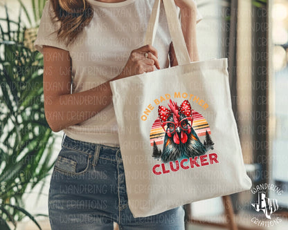 The Mother Clucker Tote Bag features a sassy mama hen wearing a red polka dot bow and trendy red glasses with the playful phrase "one bad mother clucker."