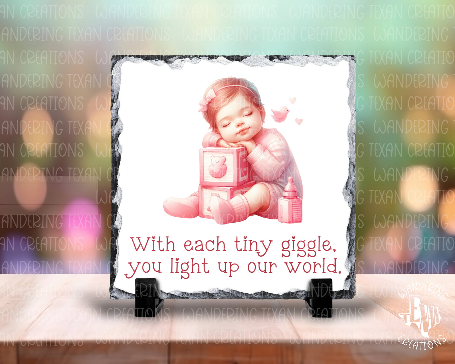 The Tiny Giggles Slate Display is a charming addition to any nursery, featuring a precious design of a sleeping baby girl on playing blocks and a heartwarming phrase.