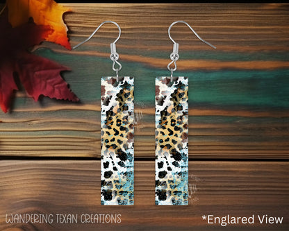 Featuring a playful mix of animal prints and a pop of teal, these sublimated, rectangle-shaped earrings add a touch of whimsy to any outfit.