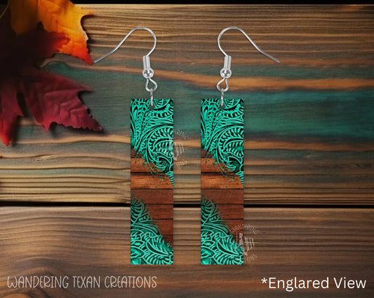 These earrings are playful and stylish with a unique design of wood slats in the background and teal fillagree overlapping the edges.