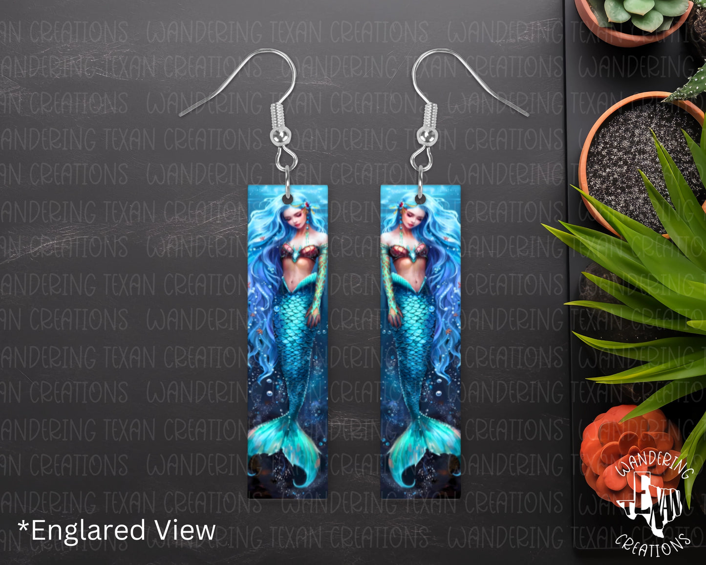  These earrings feature a sublimation design showcasing a beautiful sapphire mermaid, perfect for adding a mystic touch to any outfit. 