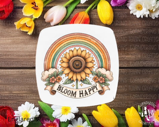 Sprinkle some joy in your life with our Bloom Happy Magnet! This charming sunflower magnet features a vibrant rainbow design and the uplifting phrase "bloom happy."