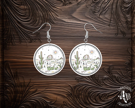 Add some adventure to your outfit with Desert Mountain Earrings! Featuring a unique desert mountain scene design, these round earrings are sure to make a statement. 