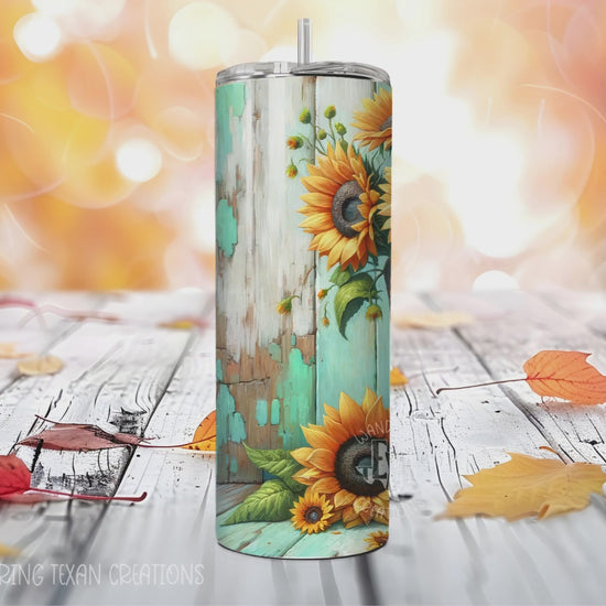 This seasonal tumbler features a playful design with cowboy boots filled with sunflowers against a rustic teal wood background.