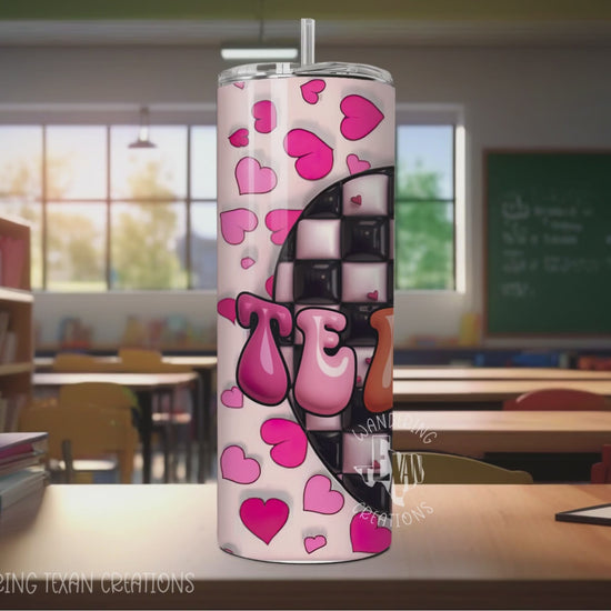 This 20 oz stainless steel, double wall tumbler comes in options with or without a handle. The sublimation design features a 3D checkered apple with the word "Teacher" and hearts in the background.