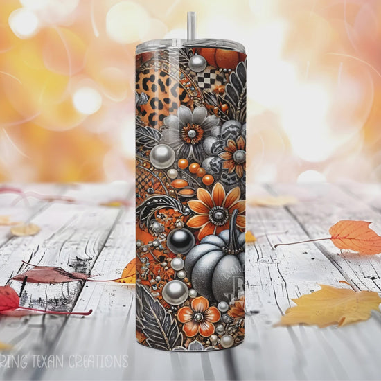 This seasonal tumbler boasts a unique design of pumpkins and fall florals in a color scheme of orange, black, white, and silver.