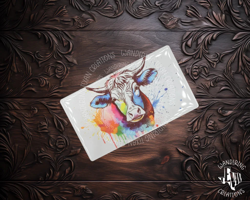 Add some pizzazz to your fridge with our horned cow magnet, featuring a playful splash of paint splatter.